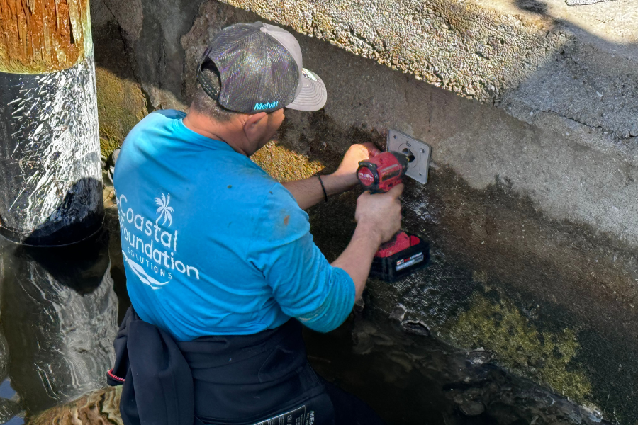 Man Installing Seawall Drain in Florida Concrete Seawall